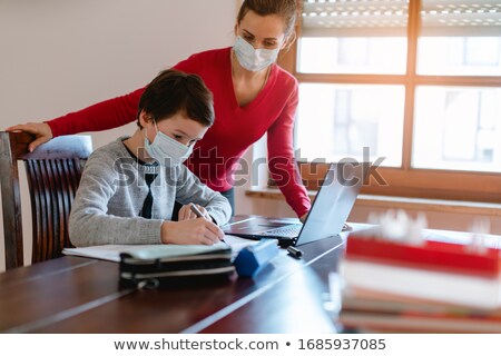 Stock photo: Mother And Child Having E Learning Session With Teacher During Crisis