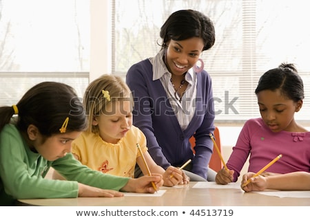 Foto stock: Teacher Helping Students In School Classroom Horizontally Frame