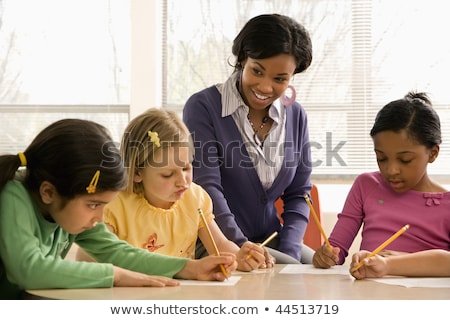 Teacher Helping Students In School Classroom Horizontally Frame Imagine de stoc © iofoto