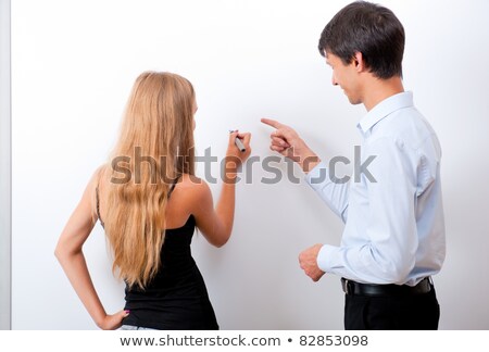 Foto stock: Closeup Of Adult Teacher With Student - Explaining Something