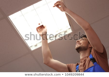 Stock foto: Installing The Ceiling Light