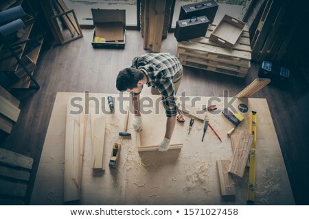 Imagine de stoc: A Carpenter Making A Wooden Frame