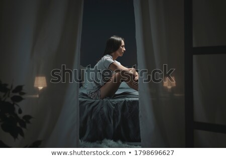 Foto stock: Sad Woman Sitting On The Bed