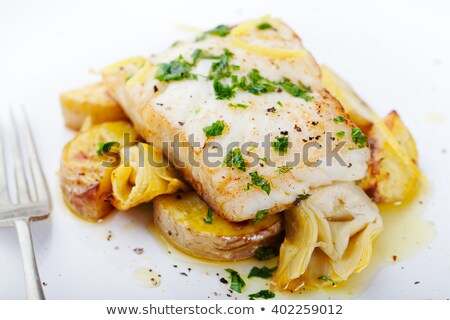 Foto stock: Roasted Cod Codfish With Baked Potatoes And Artichokes With Lemon And Herbs Sauce