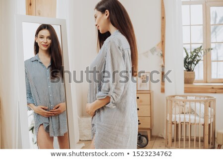 Stock foto: Pregnant Woman In Front Of Mirror