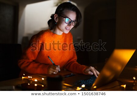 Stock foto: Smiling Young Girl Wearing Eyeglasses Using Laptop Computer