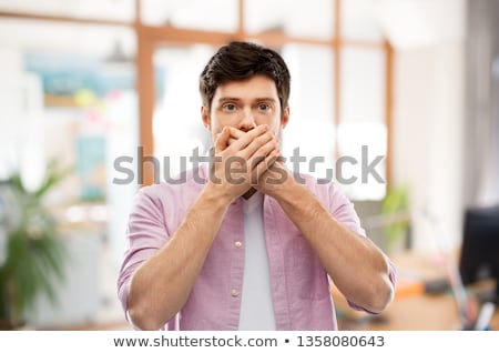 Stock fotó: Shocked Young Man Covering His Mouth By Hands