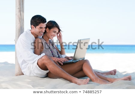 Stockfoto: Portrait Of A Woman On The Beach With Laptop