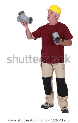 [[stock_photo]]: Grey Haired Plumber Holding Two Replacement Parts