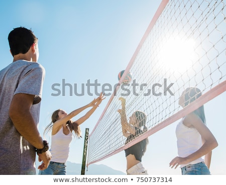 Foto stock: Young Woman With Ball Playing Volleyball On Beach