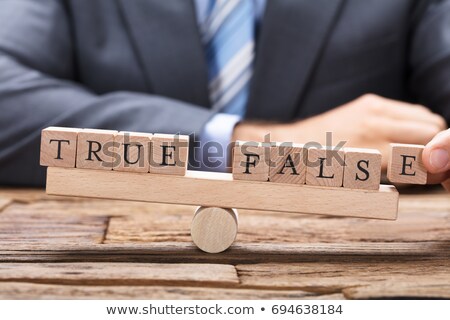 Stock foto: Businessman Holding True And False Blocks