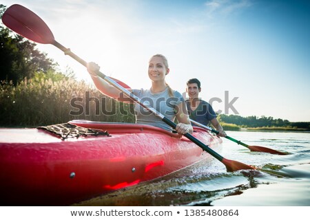 Stok fotoğraf: Confident Couple Paddling Over Lake