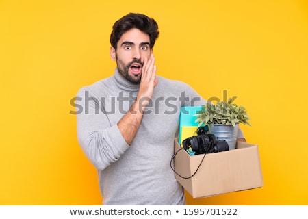 Foto d'archivio: Young Handsome Man Moving In To New House With Boxes