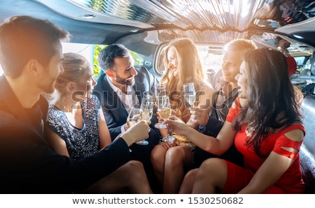 Stock fotó: Group Of Women And Men Clinking Glasses In A Limousine