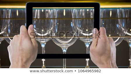 Foto stock: Man Holding Tablet Device Upside Down