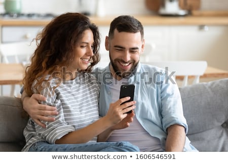 Сток-фото: Guy And Girl Messaging On Cell Phone