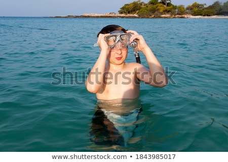 ストックフォト: Young Boy With Brown Hair Enjoys Swimming