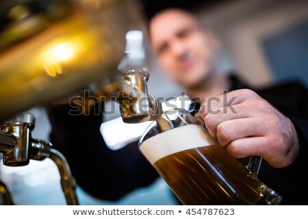 Stok fotoğraf: Brewer Filling Beer In Beer Glass From Beer Pump