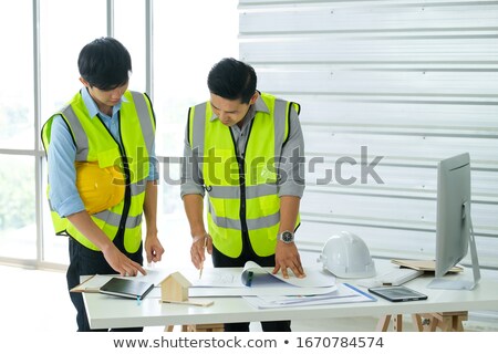 Foto d'archivio: Blueprints On Desk Two Architects There