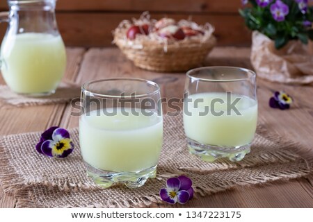 Stock photo: Two Glasses Of Fresh Whey With Pansy Flowers