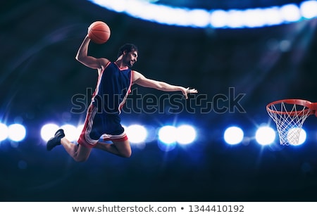 Zdjęcia stock: Acrobatic Slam Dunk Of A Basket Player In The Basket At The Stadium