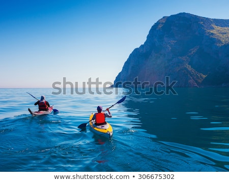 Stockfoto: Beautiful Couple Sailing Kayak On Lake