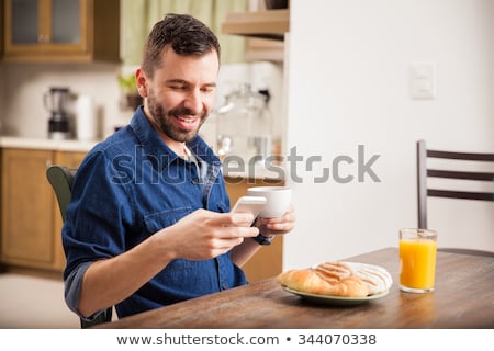 Сток-фото: Portrait Of A Handsome Young Man Having Breakfast