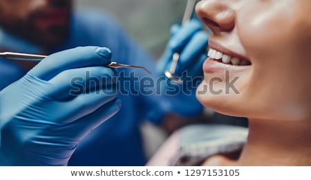 Foto stock: Man With Toothache And Dentist At Dental Clinic