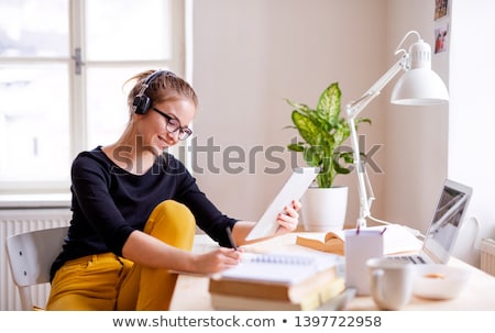 Stok fotoğraf: Young Teenager Preparing For Exams Studying At A Desk Indoors