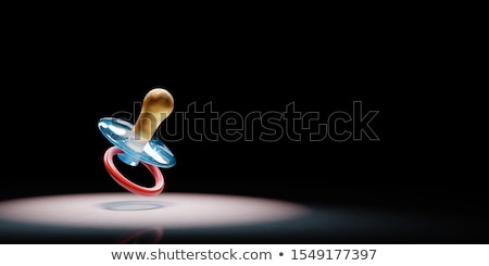 Foto stock: Babys Pacifier Spotlighted On Black Background
