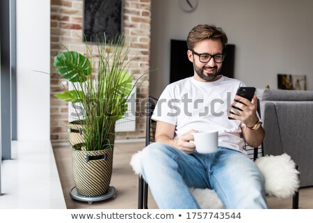 Foto d'archivio: Businessman Sitting On Chair With Laptop And Soft Drink