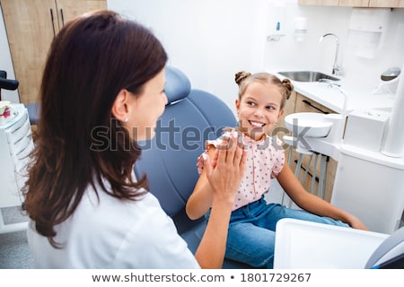 Foto d'archivio: Smiling Girl Sitting On A Chair