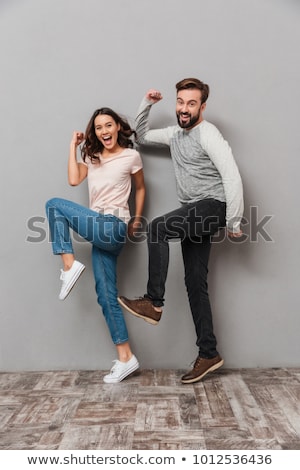 Stock photo: Handsome Young Man Dancing Over Gray Background