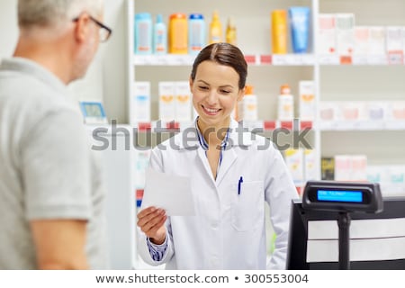 Stockfoto: Senior Apothecary At Pharmacy Cash Register