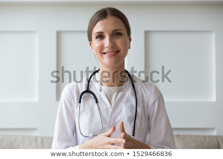 Foto stock: Young Female Doctor Cardiologist Sitting At The Hospital