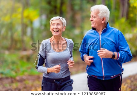 ストックフォト: Man And Woman Walking Together In Autumn Park