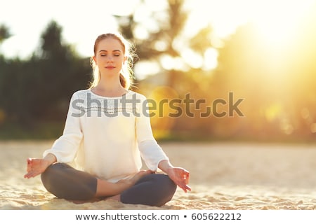 Stock photo: Beautiful Relaxed Young Woman Meditating Outdoors