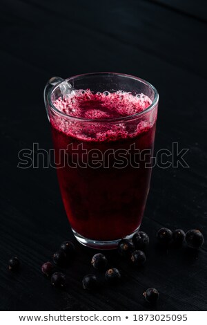 Foto stock: Cup Of Tea With Berries On The Dark Stone Table