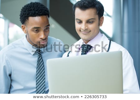 Foto stock: Young Hispanic Doctor Using A Laptop