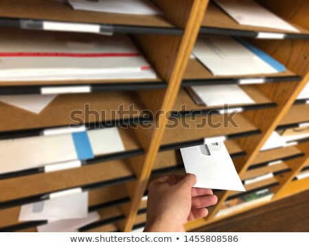 ストックフォト: A Businessman Handing And Sending In A Envelope Letter On A Wood