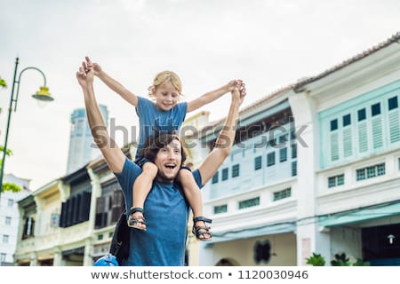 Stock photo: Dad And Son In The Background Of Old Houses In The Old Town Of Georgetown Penang Malaysia