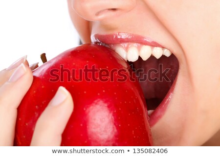 Foto d'archivio: Brunette Biting Into Red Apple