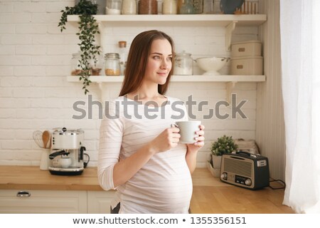 Stockfoto: Young Woman Having A Hot Drink At Home