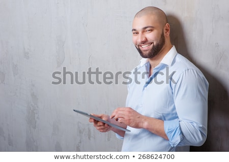 Foto stock: Young Business Man Leaning On A Wall While