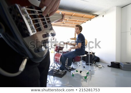 Stockfoto: Young Man Playing Electric Guitar And Looks To Side