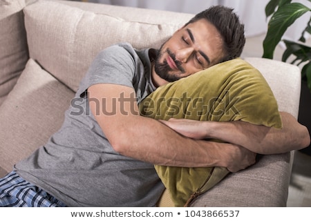 Stockfoto: A Young Man Having A Nap On Couch