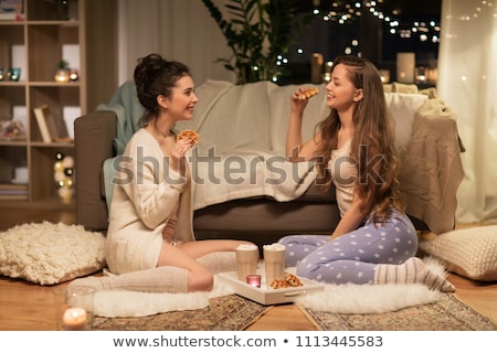 Foto stock: Happy Female Friends Eating Waffles At Home