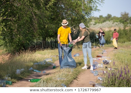 Zdjęcia stock: Man Collecting Garbage On The Forest