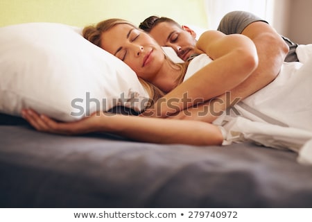 Zdjęcia stock: Young Adult Heterosexual Couple Lying On Bed In Bedroom