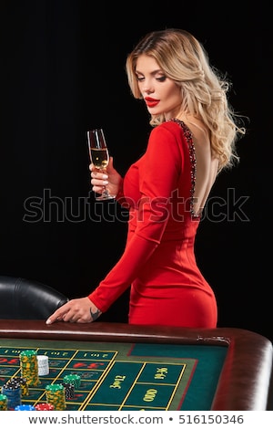 Foto stock: Woman Gambling On Red Table